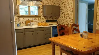 a kitchen with a wooden table and a wooden table and a wooden tableablish at Aunt Jane's Guest House in Put-in-Bay