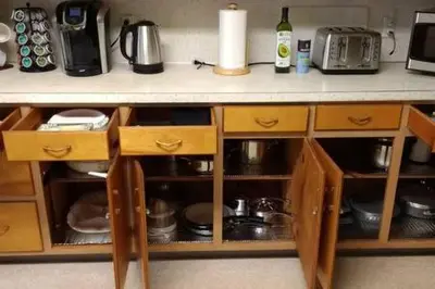 a kitchen counter with wooden drawers and a counter top at Picasso's Condo in Van Wert