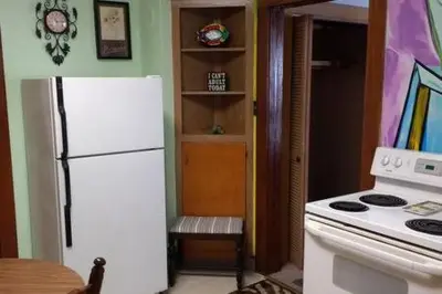 a kitchen with a white refrigerator and a stove at Picasso's Condo in Van Wert