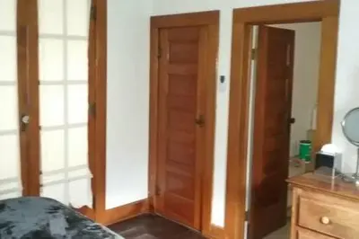 a room with two wooden doors and a bedroom at Picasso's Condo in Van Wert