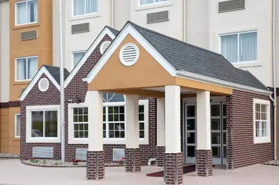a small building with a roof in front of a building at Microtel Inn & Suites by Wyndham Charleston in Charleston