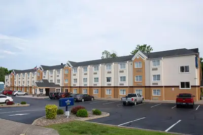 a row of apartment buildings in a parking lot at Microtel Inn & Suites by Wyndham Charleston in Charleston