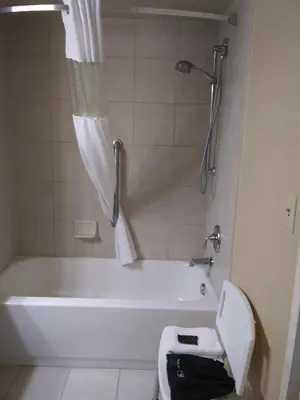 a bathroom with a tub and a toilet and a shower at Wingate by Wyndham Dayton - Fairborn in Fairborn