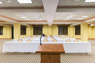 a large room with rows of tables and chairs at Wingate by Wyndham Dayton - Fairborn in Fairborn