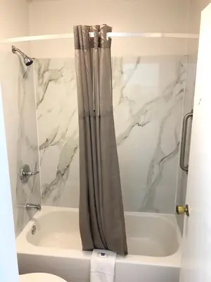 a bathroom with a shower curtain next to a tub at Motel 6-Parkersburg, WV in Parkersburg