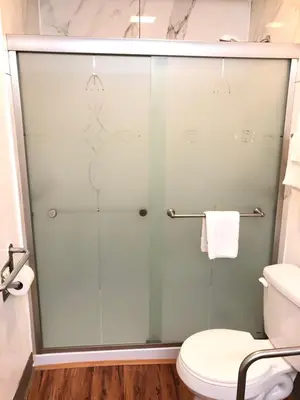 a glass shower in a bathroom with a toilet at Motel 6-Parkersburg, WV in Parkersburg