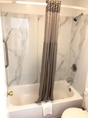 a bathroom with a shower and a tub and a toilet at Motel 6-Parkersburg, WV in Parkersburg