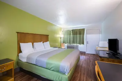 a hotel room with a bed and a television at Motel 6-Parkersburg, WV in Parkersburg