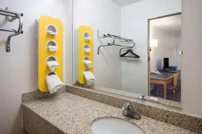 a bathroom with a sink and a mirror at Motel 6-Parkersburg, WV in Parkersburg