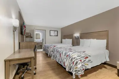 a hotel room with two beds and a desk at Red Roof Inn Georgetown, KY in Georgetown