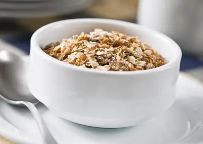 a white bowl filled with granola on a plate at Courtyard by Marriott Pittsburgh Washington Meadow Lands in Washington