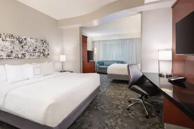 a hotel room with a bed and a desk and a chair at Courtyard by Marriott Pittsburgh Washington Meadow Lands in Washington