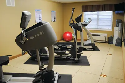 a gym with two exercise bikes in a room at Microtel Inn & Suites By Wyndham Mineral Wells/Parkersburg in Mineralwells