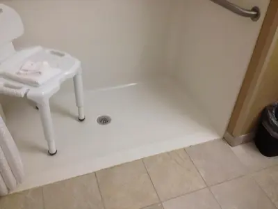 a bathroom with a white sink and a bath tub at Microtel Inn & Suites By Wyndham Mineral Wells/Parkersburg in Mineralwells