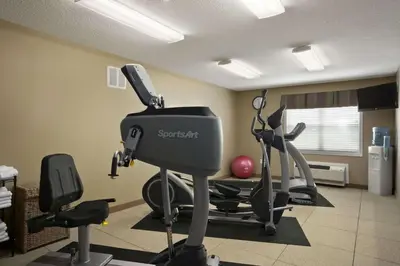a room with a gym with exercise equipment in it at Microtel Inn & Suites By Wyndham Mineral Wells/Parkersburg in Mineralwells