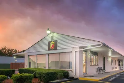 a building with a sign on the side of it at Super 8 by Wyndham Centerville-Richmond in Centerville