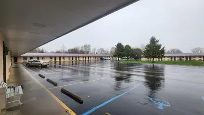an empty parking lot in front of a building at Super 8 by Wyndham Centerville-Richmond in Centerville