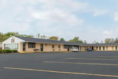an empty parking lot in front of a motel at Super 8 by Wyndham Centerville-Richmond in Centerville