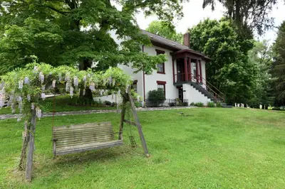 a swing in a yard in front of a house at The Pines of Dresden in Dresden