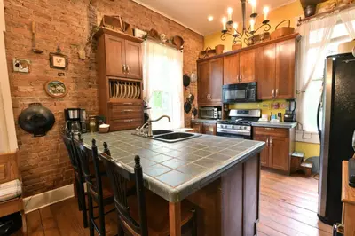 a kitchen with wooden cabinets and a counter top at The Pines of Dresden in Dresden