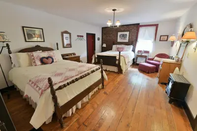 a bedroom with two beds and a living room at The Pines of Dresden in Dresden