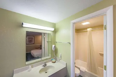 a bathroom with a sink and a toilet and a shower at Rodeway Inn Wauseon in Wauseon