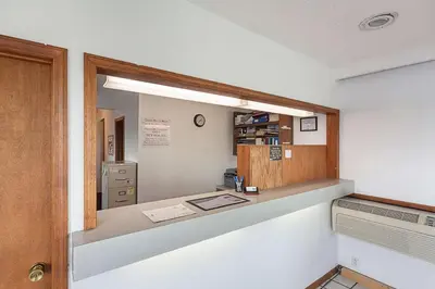 an office with a desk and a mirror at Rodeway Inn Wauseon in Wauseon