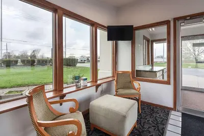 a waiting room with two chairs and a window at Rodeway Inn Wauseon in Wauseon