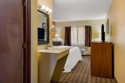 a hotel room with a bed and a sink at Quality Inn Ashland East in Ashland