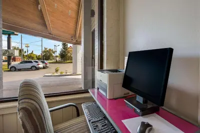 a computer on a desk with a monitor and a keyboard at Quality Inn Ashland East in Ashland