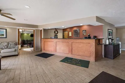 a hotel lobby with a reception desk and a couch at Quality Inn Ashland East in Ashland