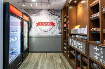 a grocery store aisle with a treats sign on the wall at Hampton Inn & Suites Wilder in Wilder