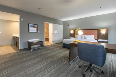 a hotel room with a bed and a desk at Hampton Inn & Suites Wilder in Wilder