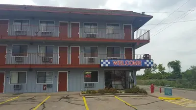 a welcome sign in front of a building at Travel Inn in Sharonville