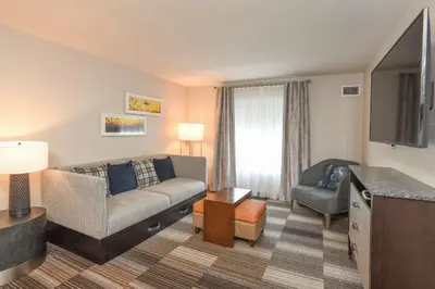 a living room with a couch and a chair at Homewood Suites Cincinnati Airport South-Florence in Florence