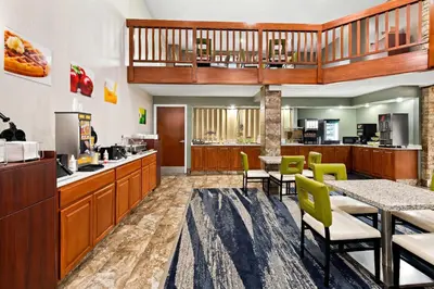 a lobby of a fast food restaurant with a table and chairs at Quality Inn Mason Near Kings Island in Mason