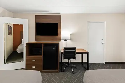 a hotel room with a desk and a television at Quality Inn Mason Near Kings Island in Mason