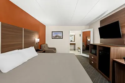 a hotel room with a bed and a flat screen tv at Quality Inn Mason Near Kings Island in Mason