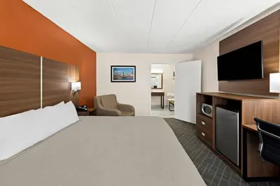 a hotel room with a bed and a flat screen tv at Quality Inn Mason Near Kings Island in Mason