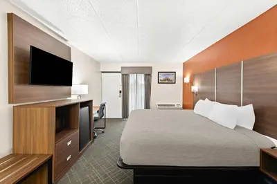 a hotel room with a bed and a flat screen tv at Quality Inn Mason Near Kings Island in Mason