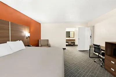 a hotel room with a bed and a desk at Quality Inn Mason Near Kings Island in Mason