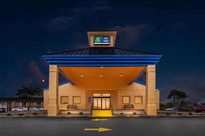 a building with a clock on the top of it at Quality Inn Mason Near Kings Island in Mason
