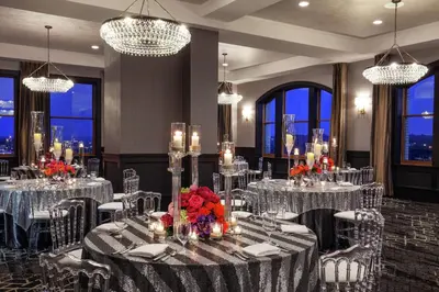 a dining room with tables and chairs and chandeliers at Doubletree By Hilton Youngstown Downtown in Youngstown