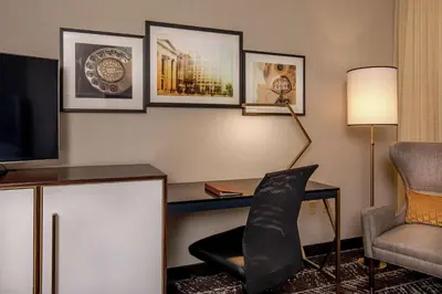 a hotel room with a desk and a chair and a television at Doubletree By Hilton Youngstown Downtown in Youngstown