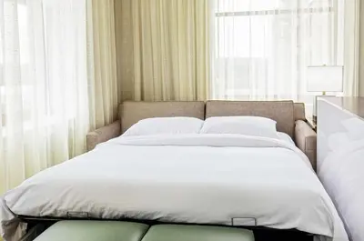 a bed in a room with a large window at Doubletree By Hilton Youngstown Downtown in Youngstown