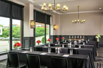 a conference room with tables and chairs and windows at Doubletree By Hilton Youngstown Downtown in Youngstown
