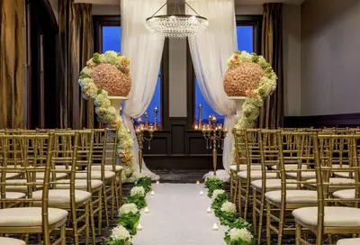 a row of chairs in a aisle with flowers at Doubletree By Hilton Youngstown Downtown in Youngstown