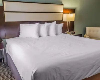 a large white bed in a hotel room at Quality Inn Streetsboro - Kent in Streetsboro