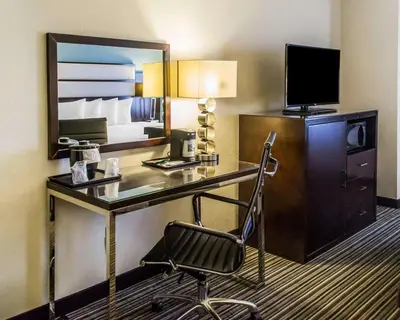 a hotel room with a desk and a chair at Quality Inn Streetsboro - Kent in Streetsboro