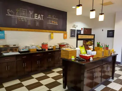 a restaurant kitchen with a counter with food on it at Hampton Inn Stow in Stow